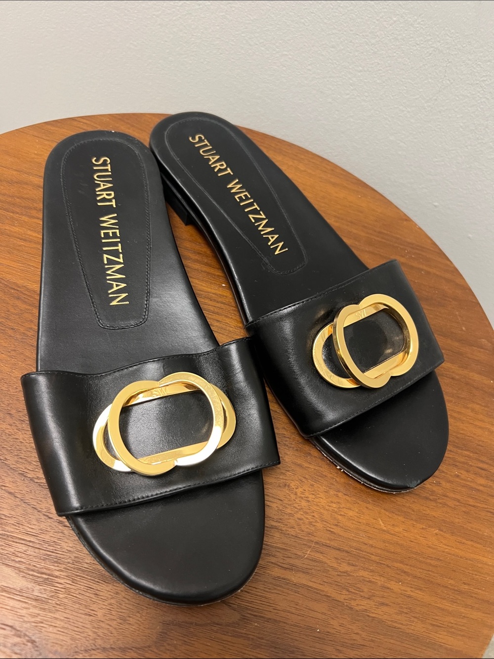 Stuart Weitzman Black Leather Slide Mules with Gold Buckle